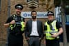 First Miinister Humza Yousaf stands with tow officers from Police Scotland