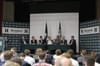 Article: Far right European politicians join Homeland UK conference Image description: a panel discussion featuring seven men