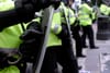 Article headline: Far right accused of racism, threats and attacks at anti-migrant protests Image description: British police