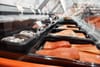 Trays of fresh salmon fillets and whole fish displayed on ice in a supermarket seafood counter, with price tags and labels clipped above the containers.